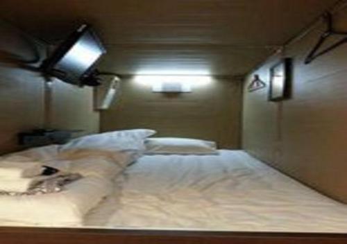 a bedroom with a large white bed with lights on it at Hakodate - Hotel / Vacation STAY 34006 in Hakodate