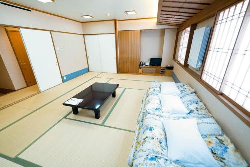 a room with a bed and a coffee table at Hashima - Hotel - Vacation STAY 52732v in Hashima