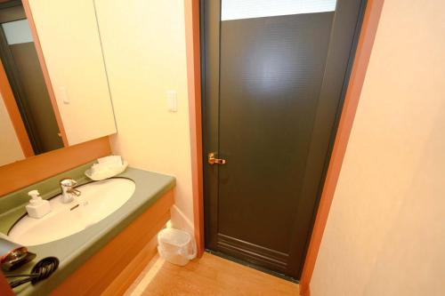 a bathroom with a sink and a black door at Hashima - Hotel - Vacation STAY 52815v in Hashima