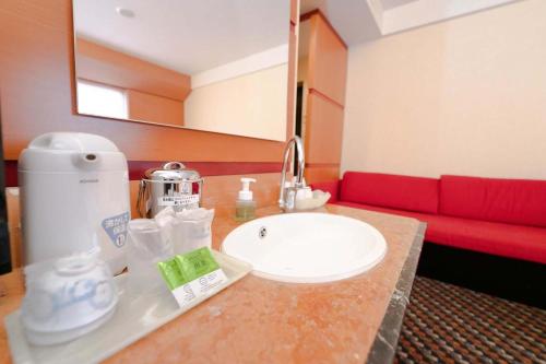 a bathroom with a sink and a red couch at Hashima - Hotel - Vacation STAY 51161v in Hashima