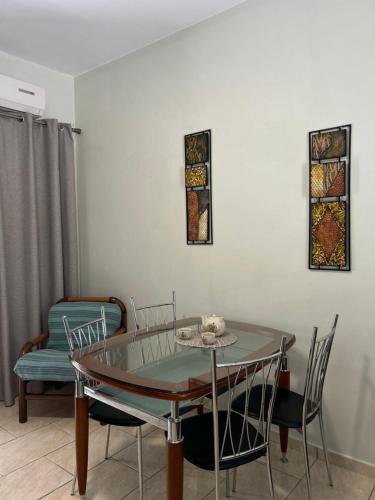 a dining room with a glass table and chairs at VILLA ERMIONI in Melíkia
