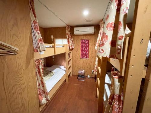 a small room with bunk beds in it at Guesthouse Otaru Wanokaze women's domitory / Vacation STAY 32191 in Otaru