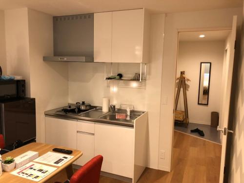 a small kitchen with a sink and a table at Time - Vacation STAY 18889v in Kagoshima