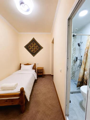 a bedroom with a bed and a shower at Shahina in Samarkand