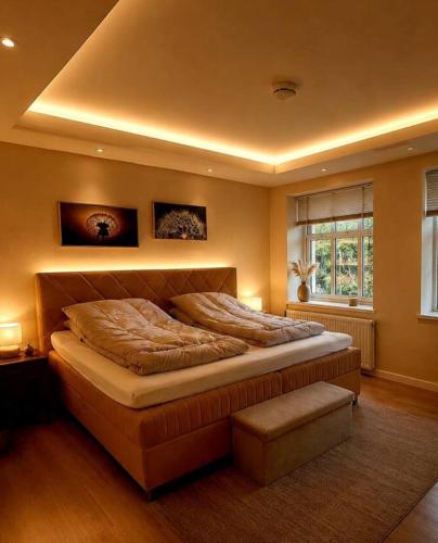 a bedroom with a large bed and a window at 4SEASONS - Golden Spring Suite in Aalborg