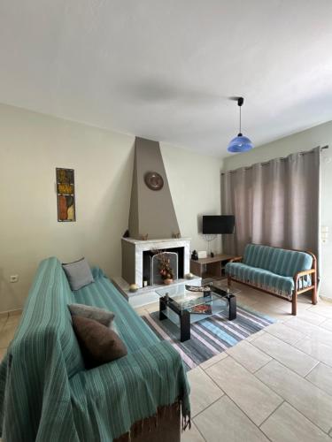 a living room with a couch and a fireplace at VILLA ERMIONI in Melíkia
