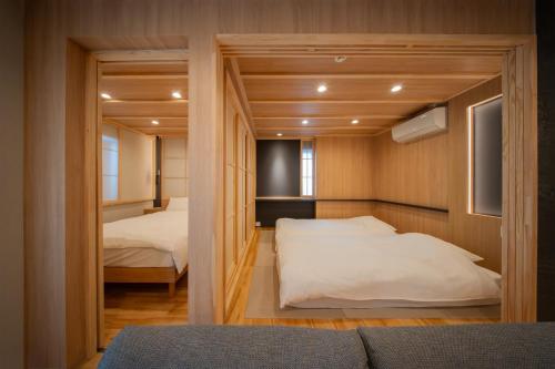 a small bedroom with two beds and a closet at winco - Vacation STAY 06660v in Tokyo