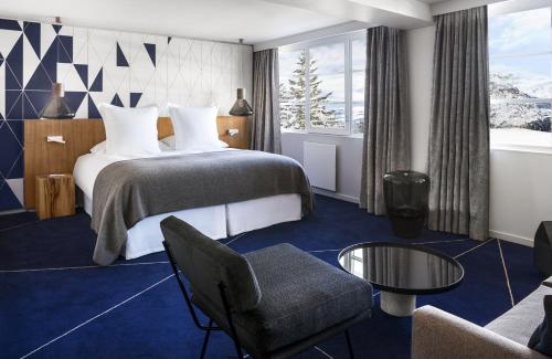 a hotel room with a bed and a couch at White 1921 Courchevel in Courchevel