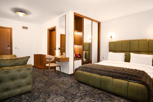 a hotel room with a bed and a desk at Alexander Resort in Sopot