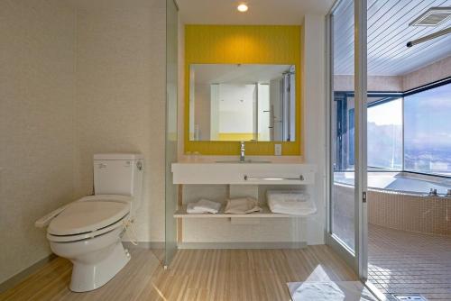 a bathroom with a toilet and a sink and a tub at Hotel Cocoa - Vacation STAY 29916v in Sakura