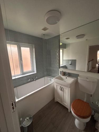 a bathroom with a tub and a toilet and a sink at Number 4 in Avington