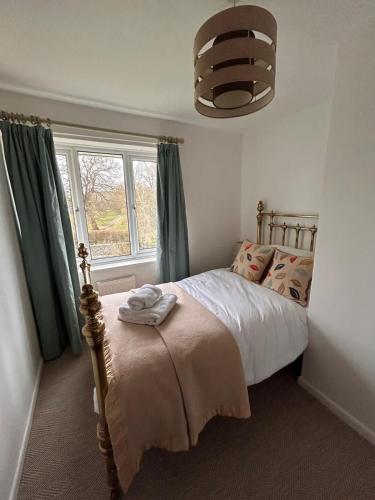 a bedroom with a bed and a window at Number 4 in Avington