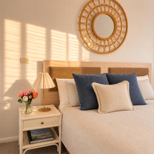 a bedroom with a bed with a table with a mirror at Newly Restyled Resort 2 Bedroom Unit Oaks Pacific Blue in Salamander Bay
