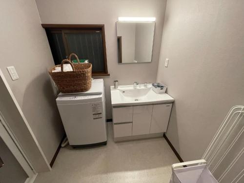 a small bathroom with a sink and a mirror at Hakusyu - Vacation STAY 11460v in Aso