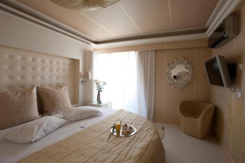 a bedroom with a bed with a tray of food on it at The Crystal Blue Hotel in Athens