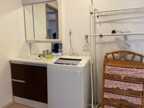 a bathroom with a sink and a washing machine at Lavender - Vacation STAY 26426v in Nishina