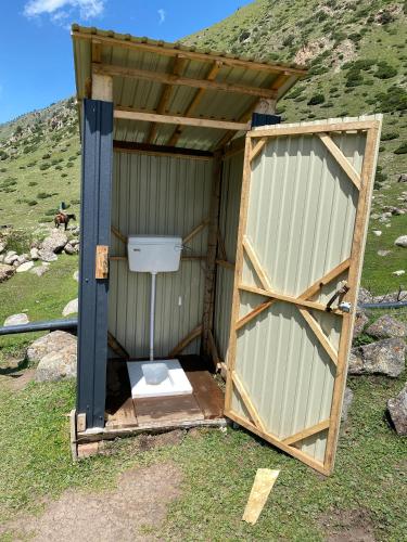 a outhouse with a toilet inside of it at Kerben Yurt Camp Arashan in Mineralʼnyy Istochnik Altyn-Arasan