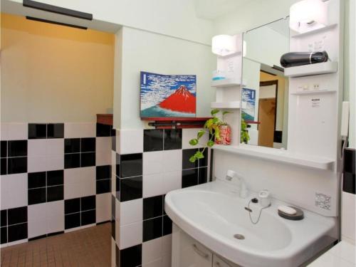 a bathroom with a sink and a mirror at Hostel Zen - Vacation STAY 91871v in Yokohama