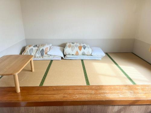 a room with a couch with pillows on the floor at Hotel Yamadaso - Vacation STAY 41353v in Nago