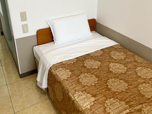 a small bed in a room with a pillow on it at Hotel Yamadaso - Vacation STAY 10193v in Nago