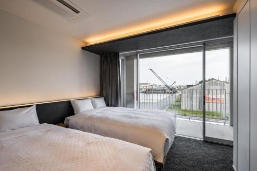 a hotel room with two beds and a large window at Hotel Dios - Vacation STAY 31184v in Awaji