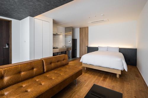 a bedroom with a bed and a couch at Hotel Dios - Vacation STAY 31424v in Awaji