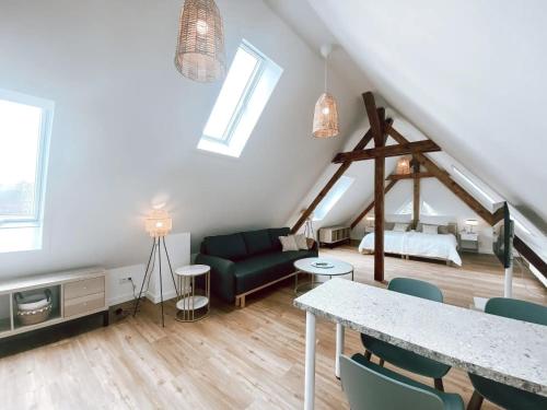a living room with a couch and a table at BetterBeds Berlin in Berlin