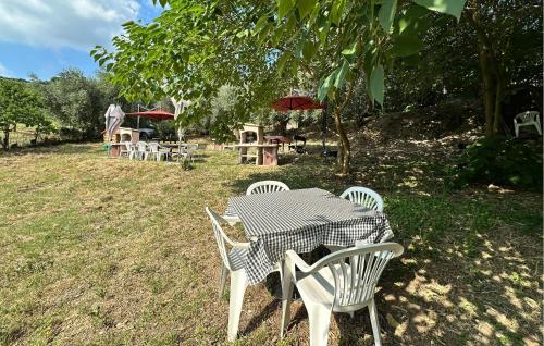 a table and chairs in a field with a tree at Rasara in Arquà Petrarca