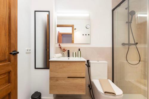 a bathroom with a toilet and a sink and a shower at Can Perla in Sóller