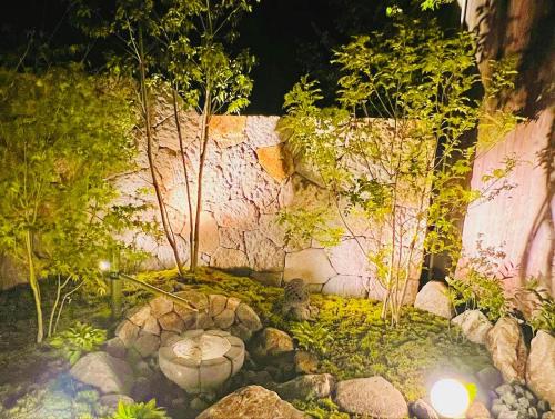 a garden with rocks and trees and a stone wall at CONNECT, - Vacation STAY 16929v in Arita