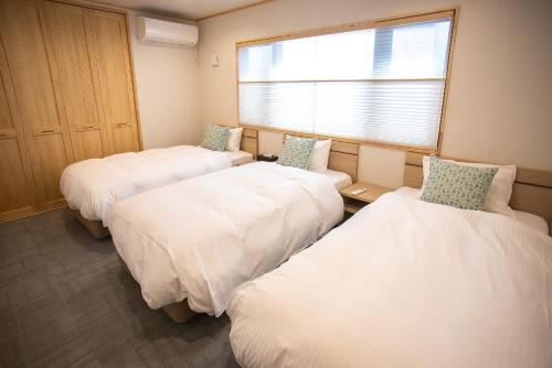 a room with three beds and a window at Nagi - Vacation STAY 55367v in Katori