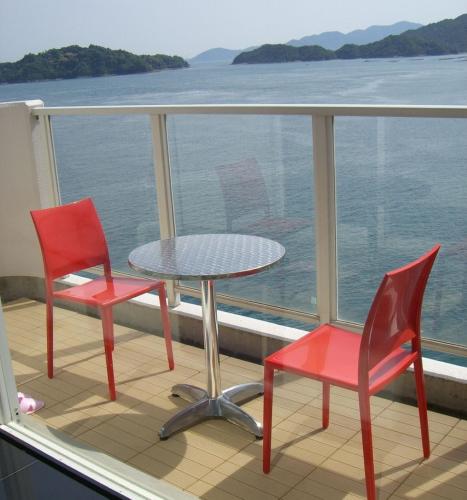 a balcony with two chairs and a table on a ship at Hotel Mare - Vacation STAY 58088v in Kure