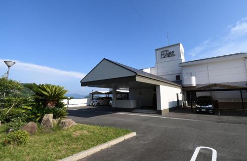 a white building with a sign that reads fire at Hotel Mare - Vacation STAY 58144v in Kure