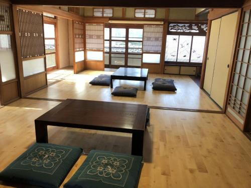 a room with a table and chairs in a room with windows at Setouchi base - Vacation STAY 48143v in Mitoyo