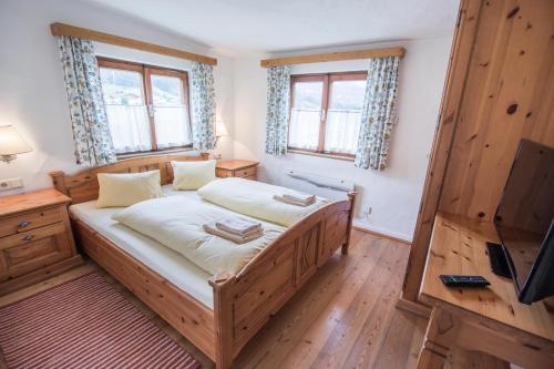 a bedroom with a bed and a flat screen tv at Ferienhaus/Chalet Schneiderhäusl in Flachau