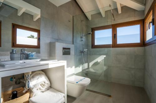 a bathroom with a toilet and a sink and a shower at Pula Golf Resort in Son Servera