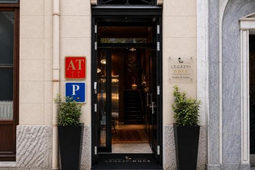 an entrance to a hotel door with two potted plants at Legazpi Doce Rooms & Suites in San Sebastián