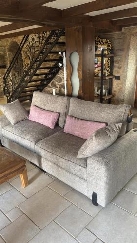 a couch with pink pillows in a living room at Villa Careixo in Castro