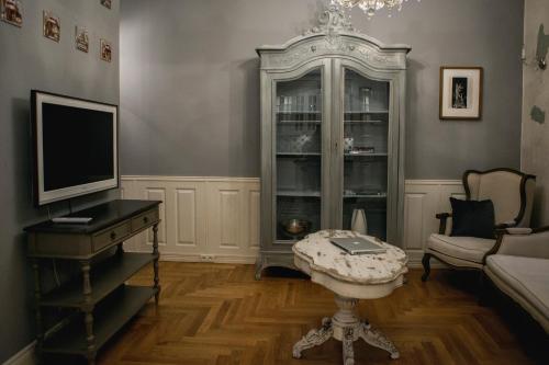 a living room with a television and a table at Royal Residence by OTR in Krakow