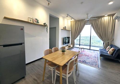 a kitchen and living room with a table and a refrigerator at MySky Putrajaya in Putrajaya
