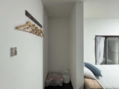 a bedroom with white walls and a bed and a window at D Hotel - Vacation STAY 89676v in Tokyo