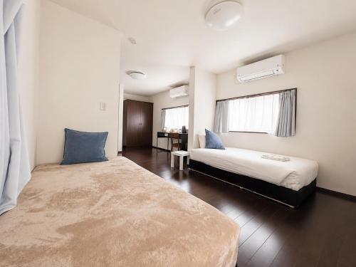 a bedroom with two beds and a window at D Hotel - Vacation STAY 78387v in Tokyo
