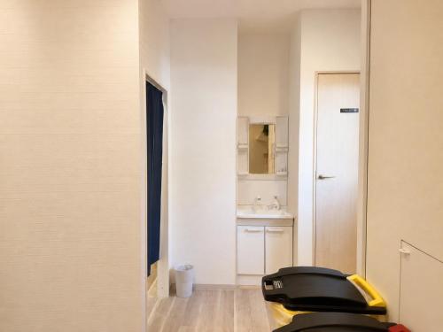 a small bathroom with a toilet and a sink at D Hotel - Vacation STAY 78387v in Tokyo
