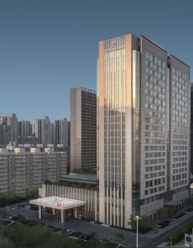 a tall building in a city with a parking lot at Renaissance Xi'an Hotel in Xi'an