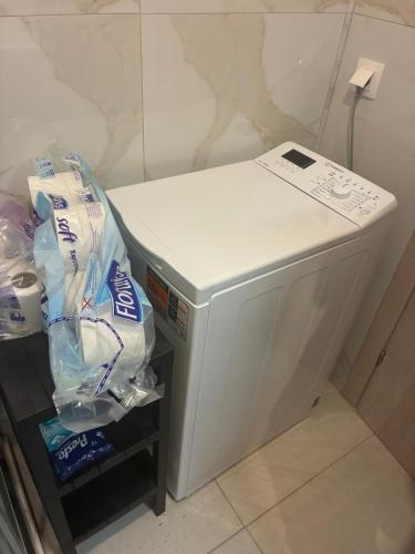 a small white refrigerator sitting in a room at Stella Apartment in Nikiti