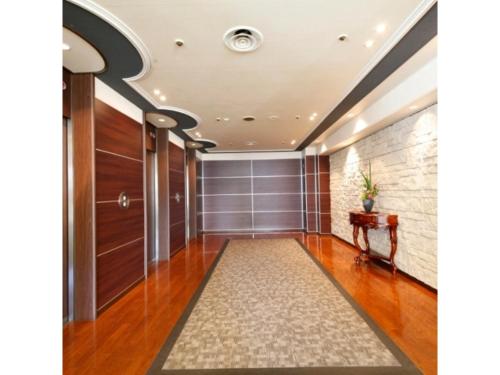 a hallway with a door and a rug at Central Hotel - Vacation STAY 99763v in Kusugaurachō