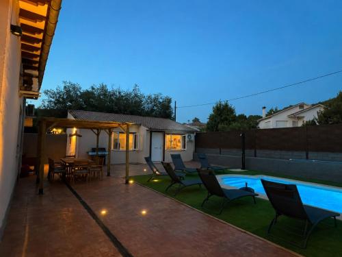 a patio with chairs and a swimming pool at night at TAYP LaParra Homes in La Parra
