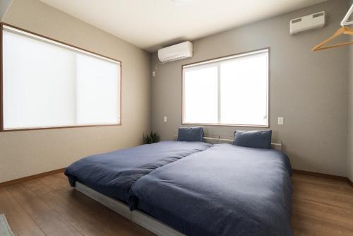 a bedroom with two large windows and a bed at HOTEL PG -2- - Vacation STAY 38335v in Onomichi