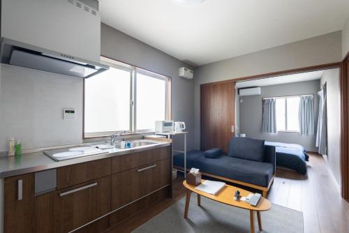 a living room with a sink and a couch in a room at HOTEL PG -2- - Vacation STAY 38335v in Onomichi