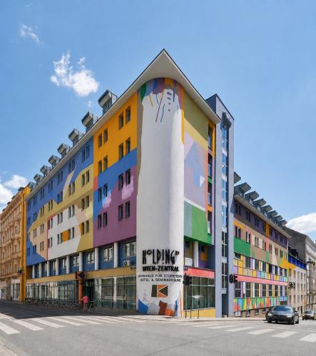 a building with a painting on the side of it at Hotel Kolping Wien Zentral in Vienna